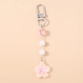 Detail of pink acrylic cherry blossom pendant with white pearls and silver lobster clasp - Pink
