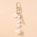 Modischer Perlen-Schlüsselanhänger mit rosa Herz-Knopf und Kristallkette auf Goldring - Rosa
