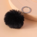 Detailed view of 8cm fluffy black faux fur pompom keychain with silver metal clip - Black