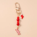 Detail of Christmas keychain featuring red beads, santa sock, and striped candy pendant - Christmas Sock & Candy