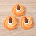 Macro detail of three resin almond biscuit charms with metallic rings for DIY jewelry making - Almond Cream Cookie / Set of 4