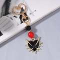 Detalle de llavero gótico con cuentas rojas y colgante de corazón con espinas de moda - Dorado Negro Corazón Espinas