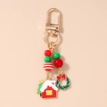 Close-up of Christmas keychain with festive gold charms, red beads, and a green wreath - Christmas House Wreath Beaded