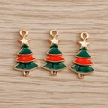 Macro detail of three green and red enamel Christmas tree charms with gold alloy base - 10 Pieces Pack / Christmas Tree