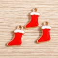 Three red enamel Christmas stocking charms with gold metal edges on a wooden background - 10 Pieces Pack / Red Christmas Sock