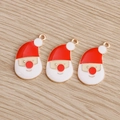 Detail shot of three Santa Claus charms with red enamel on gold metal for jewelry making - 10 Pieces Pack / Santa Claus