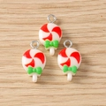 Three red and white candy lollipop pendants with green bows on a light wooden surface - Christmas Lollipop Style