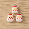 Detailed view of three resin Santa Claus pendants with metal loops for DIY jewelry making - Red Face Santa Claus Style