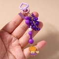 Detail van paarse kralen Halloween sleutelhanger met oranje pompoenmeisje hanger - Halloween Pompoen Meisje (2026)