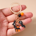 Detail of Halloween keychain featuring bat, ghost, and haunted house enamel charms - Bat Ghost House Keychain