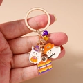 Detail of Halloween keychain featuring ghosts, pumpkin lantern, and eyeball cake charms - Pumpkin Ghost Cake Keychain