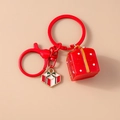 Dettaglio portachiavi natalizio 3D rosso a forma di pacchetto con pois e nastro oro - Confezione regalo di Natale