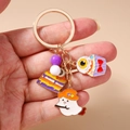 Detail of Halloween keychain with enamel ghosts, spooky cakes and eyeball pendants - Cake Ghost Eye Keychain