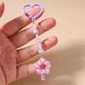Detail of beaded keychain with purple heart clasp and pink swirl lollipop charm - Purple Lollipop