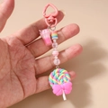 Detail of sweet lollypop keychain with pink heart clasp and striped polymer beads - Pink Ice Cream Lollipop