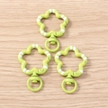 Detail view of light green floral lobster clasps with white stripes and yellow dots - 5 Pieces / Green