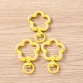 Close-up of yellow floral lobster clasps with pink dots for DIY jewelry making - 5 Pieces / Yellow