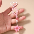 Dettaglio portachiavi con perline rosa, anello a cuore e ciondolo a lecca-lecca - Lecca-lecca Rosa