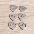 Detailed close-up of six heart-shaped LOVE charms for DIY jewelry making and crafts - Hollow Heart Style / 20 Pieces Set / Silver