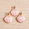 Detail of pink enamel shell charms with rose gold metal edges for DIY jewelry making - Pink