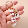 Modischer Schlüsselanhänger mit Perlenquasten, Goldring und eleganten Anhängern - Handtasche Perle (Mit Nummer 5 Schloss Und Silhouette Anhänger)