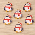 Macro detail of six cute enamel penguin pendants with red Christmas hats for DIY jewelry - Penguin with Scarf (2403)