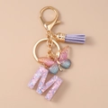 Detail view of the letter M keychain with purple glitter butterfly and leather tassel - Butterfly Letter M