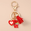 Detail of red heart, love charm and tassel keychain with gold lobster clasp - Tassel Heart