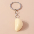 Realistic garlic bulb keychain with silver chain and metal ring on soft cream background - Garlic Shape