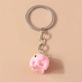 Close-up of cute pink 3D cartoon elephant keychain with polished silver metal ring - Pink