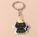 Detail of Christmas black cat keychain with colorful lights and yellow star acrylic pendant - Star Cat