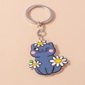 Detail of cute dark blue acrylic cat keychain with daisy patterns and silver metal ring - Cat with Flowers