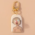 Detail of quirky acrylic keychain with bubble blowing 3D design and golden clasp - White