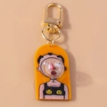 Detail of cartoon character keychain with orange acrylic and gold spring D-ring clasp - Orange