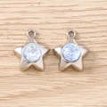 Close-up of star shaped pendants with sparkling opal center on a wood background - Silver Blue