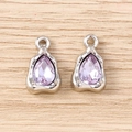 Detailed close-up of lavender teardrop gemstones set in textured silver metal frames - Silver Purple