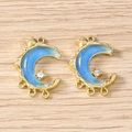 Macro shot of gold crescent moon charms with blue enamel star and sparkly rhinestone - Multi-hanging Gold Blue