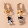 Astronaut keychains with gold lobster clasps and silver star engraved space suits - Grey Set