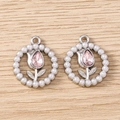 Detailed view of silver tulip charms with pink crystals and pearls on wood surface - Round Rhinestone Tulip - Silver / 5 Pieces