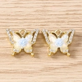 Macro view of gold butterfly pendants with rhinestones and blue resin roses - Rose Butterfly / 5 Pieces / Gold Blue