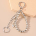 Detail view of silver punk heart keychain with barbed wire texture and metallic beads - Hollow Heart Beaded Style
