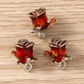 Detailed close-up of three gradient red and yellow rose flower charms with silver edges - Small Rose (Silver) / 5 Pieces