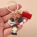Detail of graduation keychain with golden book, mortarboard, student figure and red tassel - Round Ring - Doctoral Hat Red Tassel