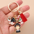 Detail of graduation keychain featuring colorful enamel charms and a red tassel accessory - Round Ring - Doctoral Hat Bouquet