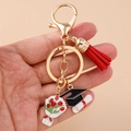 Close-up of graduation keychain with red tassel, mortarboard, and tulip charms - Lobster Buckle - Doctoral Hat Bouquet