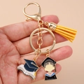 Detail of a graduation keychain featuring a yellow tassel and blue academic pendants - Lobster Buckle - Doctoral Hat Yellow Tassel