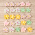 Assorted resin floral charms with silver loops for DIY jewelry on wooden background - 10 Pieces Pack / Mixed Cherry Blossom Style