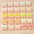 Macro detail of mixed resin flower pendants with metal rings for DIY jewelry making - 10 Pieces Pack / Mixed Fence Flower Style