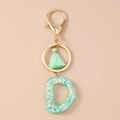 Detail of letter D resin keychain with mint green sequins, gold clasp and matching tassel - Glitter Letter D