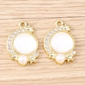 Close-up of crescent moon charms with star engravings, white opal inlay and pearl bead - Gold Base-White